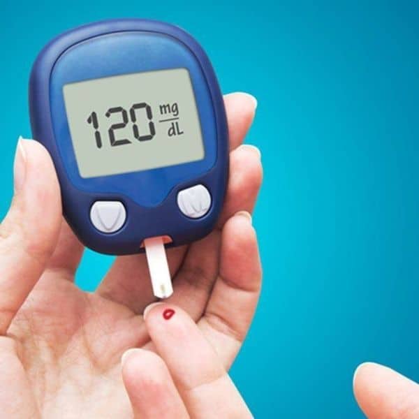 a person managing their diabetes by checking their blood sugar levels