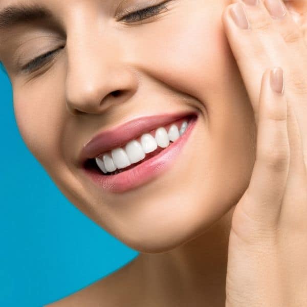 a close-up of a woman's flawless and natural-looking smile after receiving dental veneers