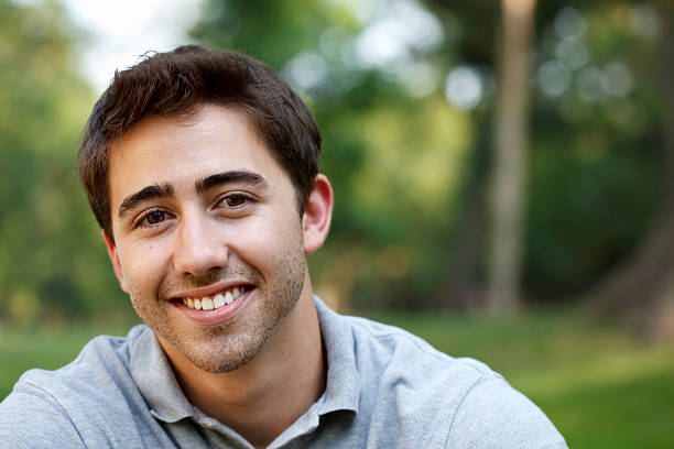 Portrait of an early 20s young man in the park.