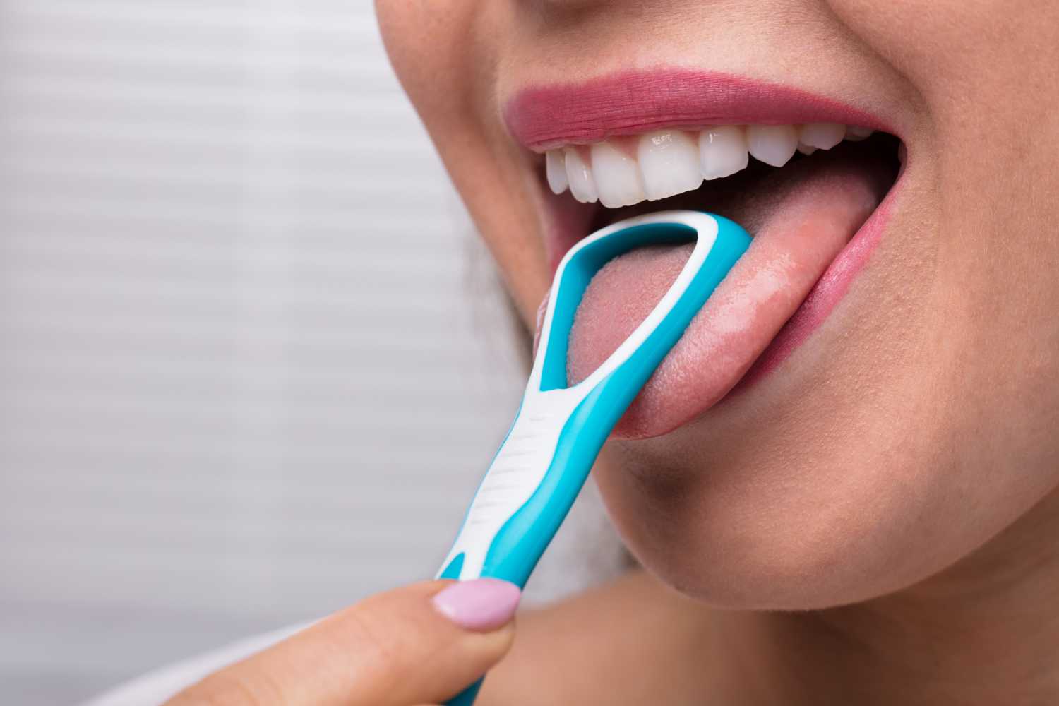 Woman Cleaning Her Tongue With Cleaner