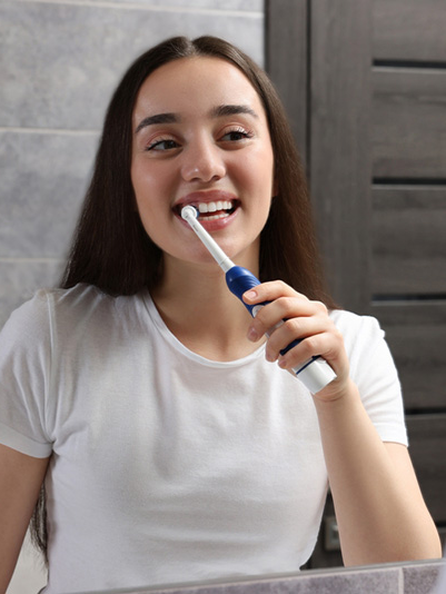 young-woman-brushing-her-teeth-electric